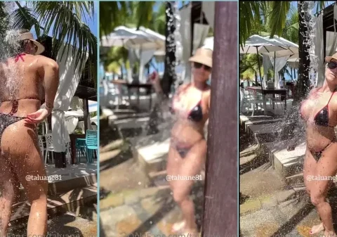 Gostosona na praia tomando um banho de chuveiro só de biquíni